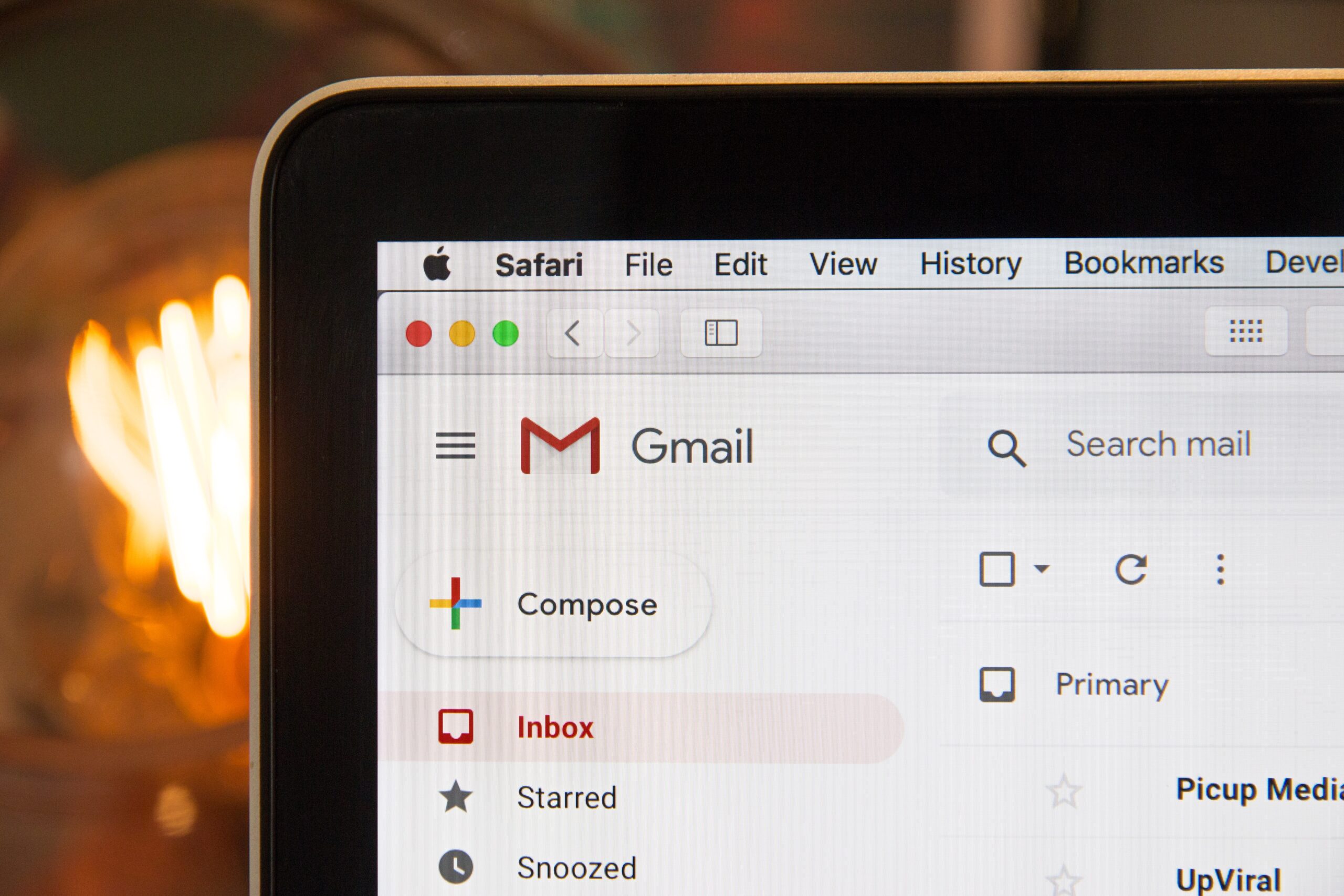 A laptop showing the top of Gmail on Safari